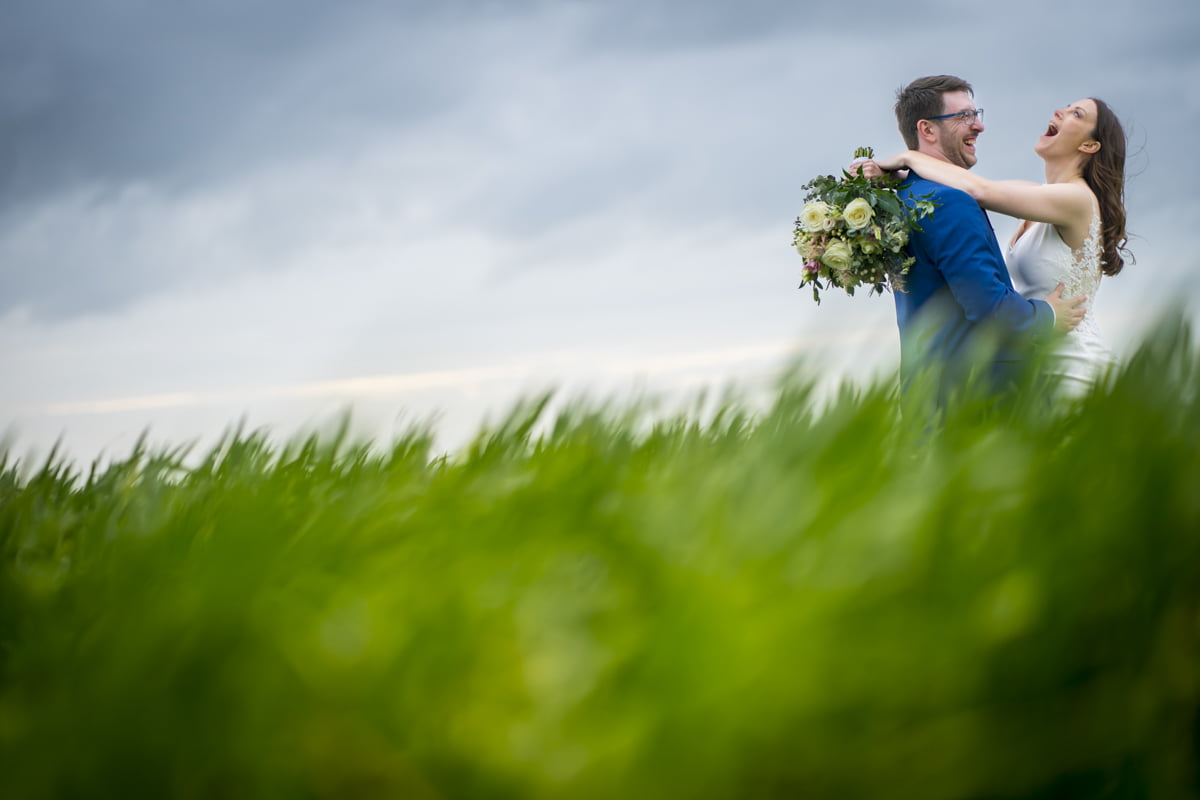 The bride and groom embrace in a creative portrait