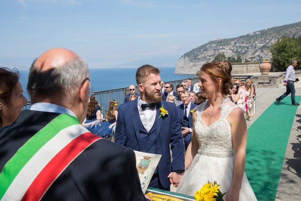 The bride and groom smile as they are married at a destination wedding in Italy