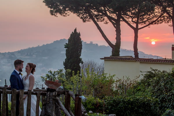 The bride and groom in front of a beautiful landscape of Italy in a destination wedding