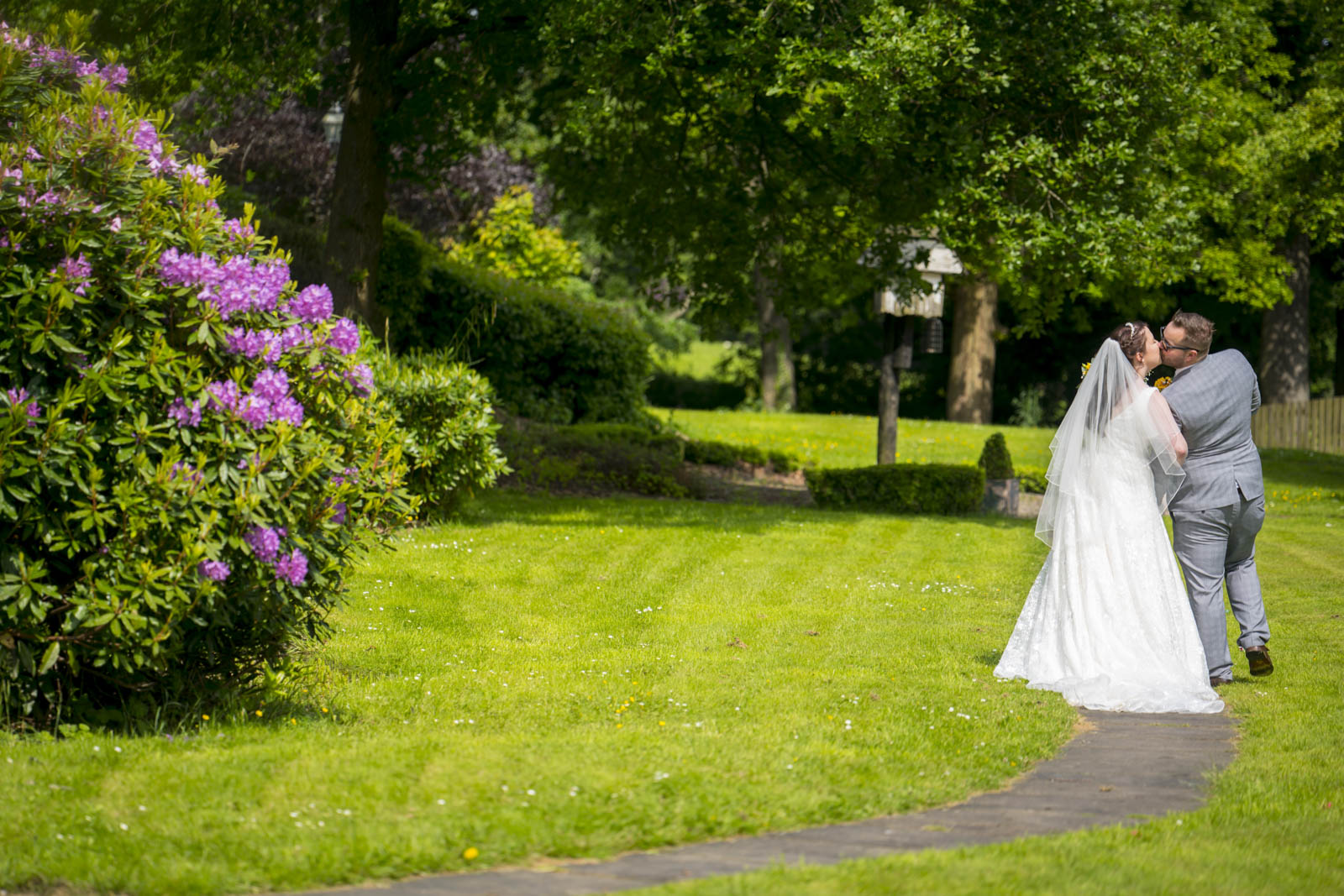 The bride and groom take a moment away to walk the grounds together natural wedding photography