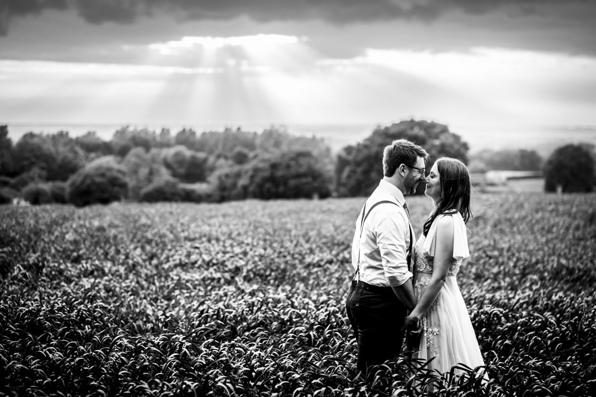The bride and groom share a moment together in the field