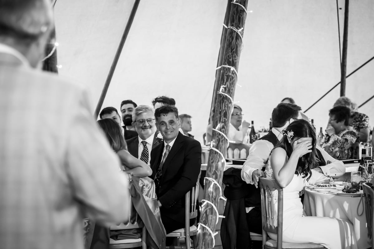 The bride hides during the wedding speeches tipi wedding photography