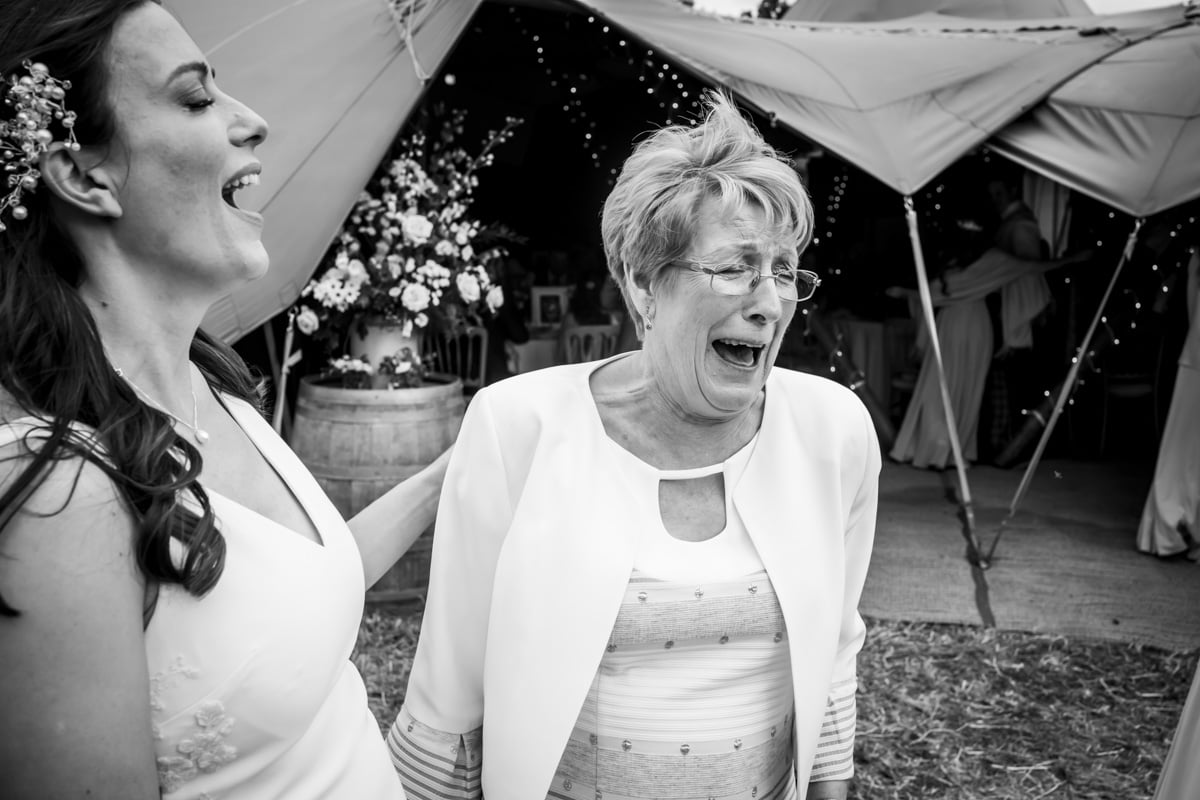 The bride laughs with her mother