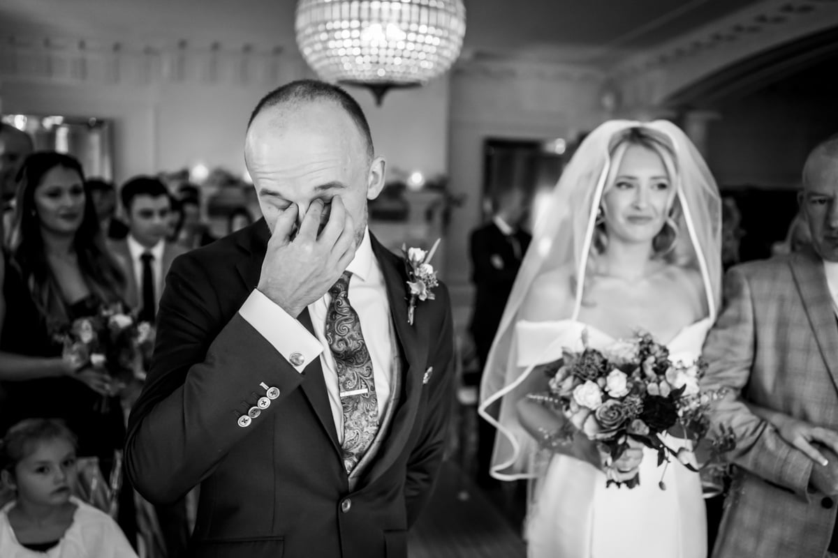 The groom is overcome with emotion at Eaves Hall