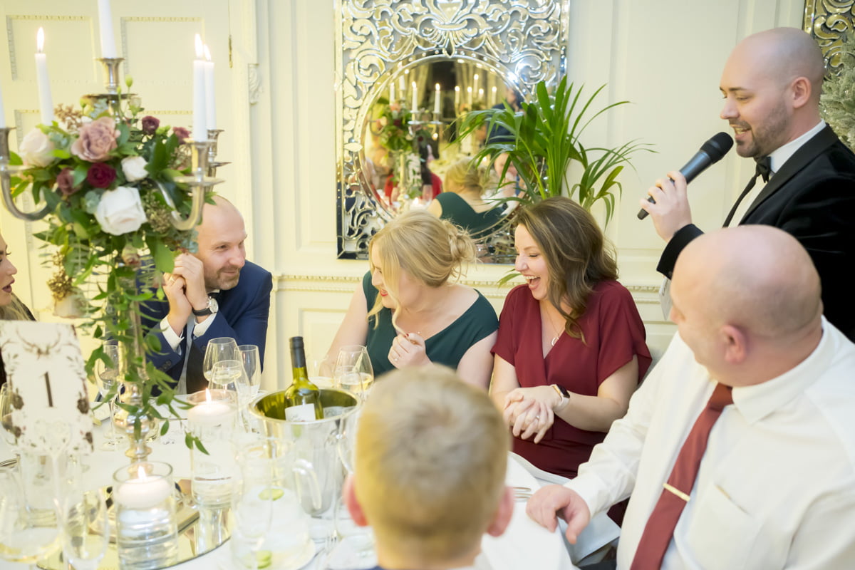 Wedding guests laugh during the wedding speeches