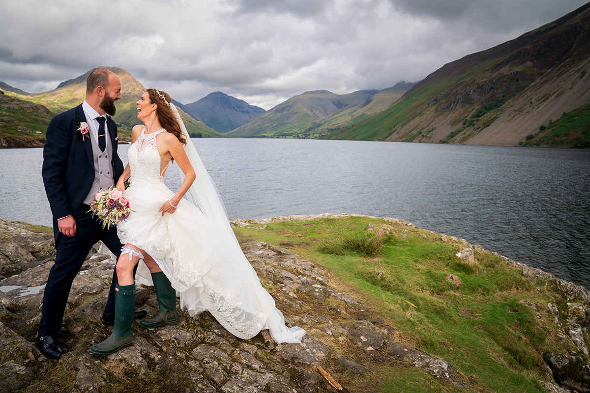 The bride flashes her wellies in this candid moment in the Lake District