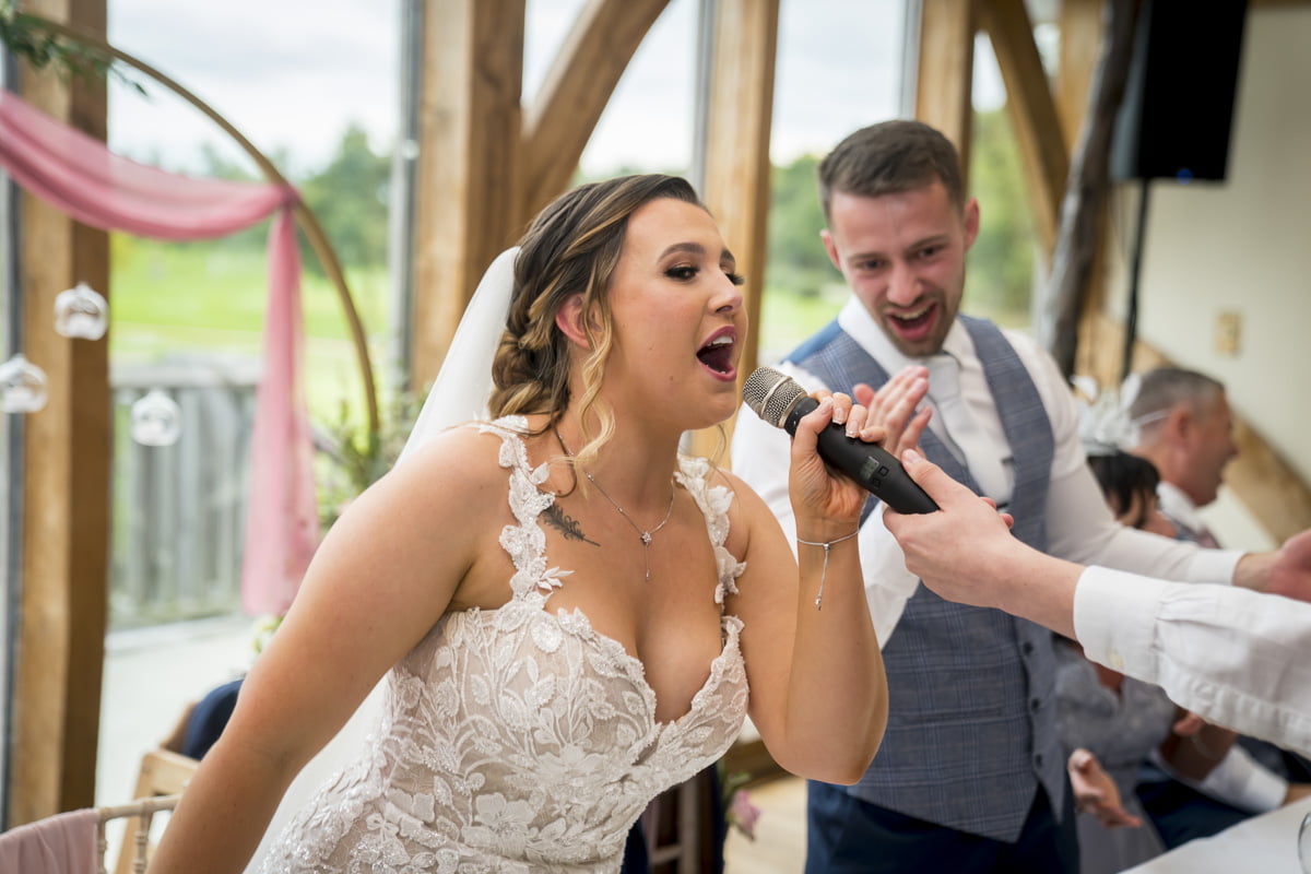 The bride sings along with the singing waiters